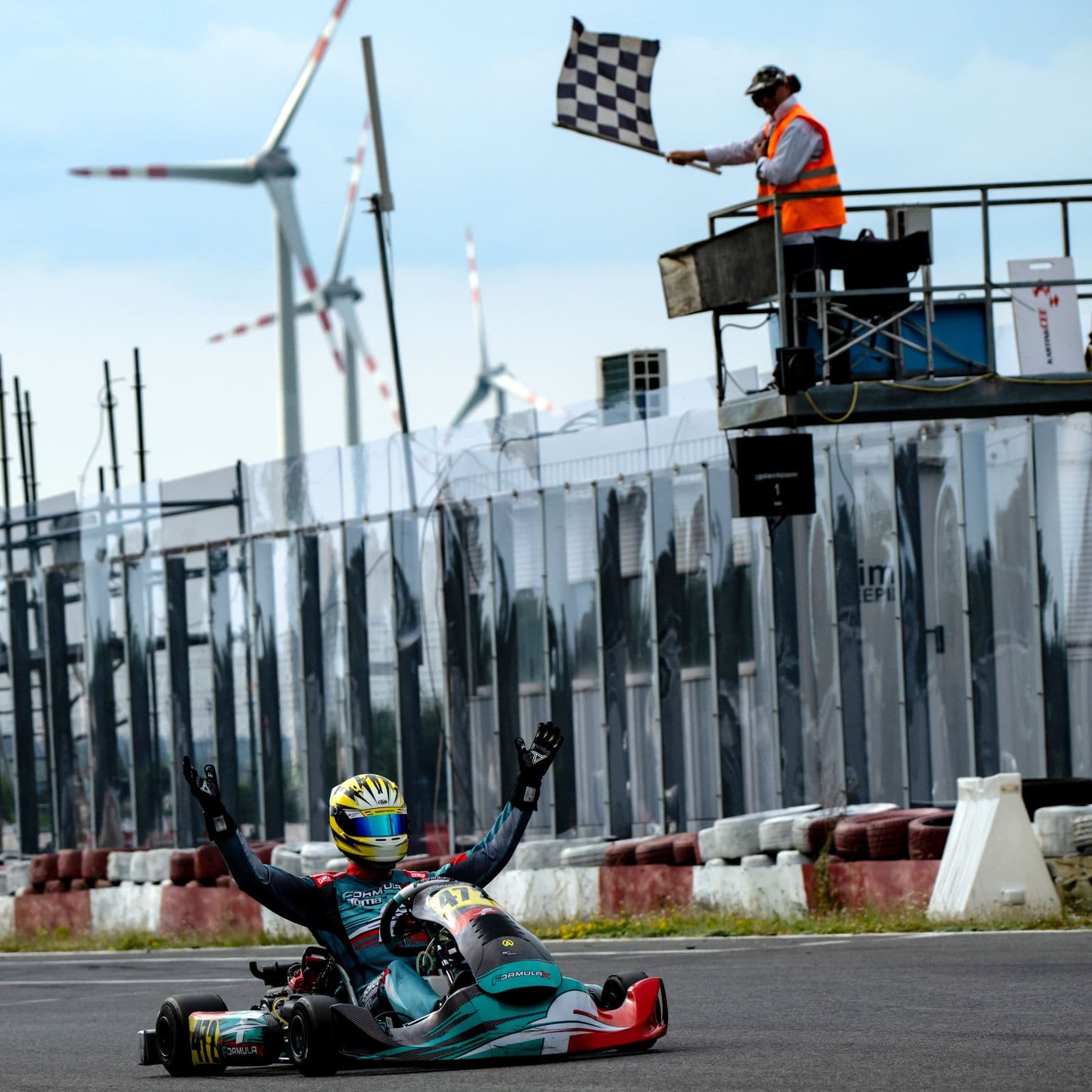 Donát raises his arms at the chequered flag, Bruck